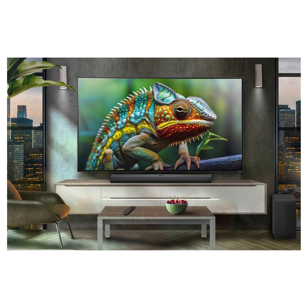 Soundbar with separate subwoofer speaker, positioned under a TV in dark finish