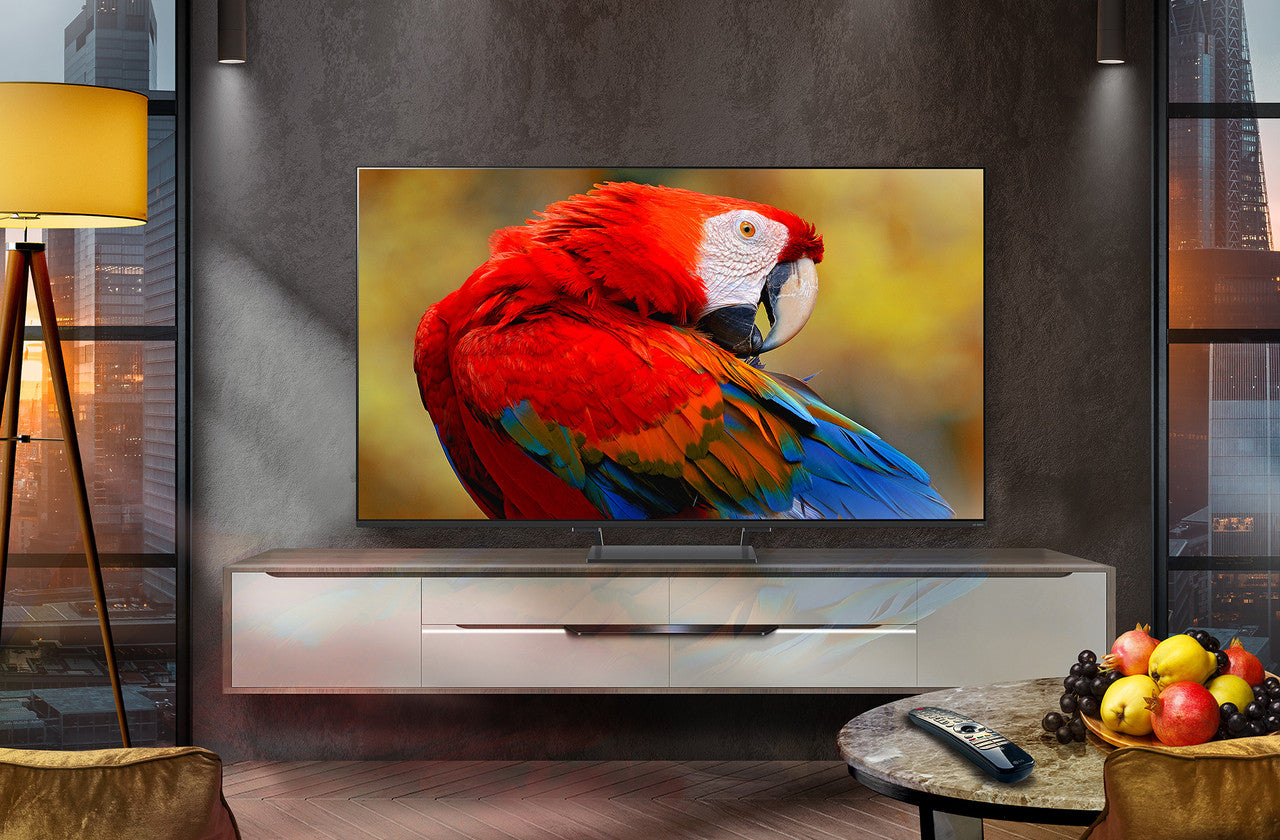 Mini LED 4K Smart TV on a console with a small remote on the surface