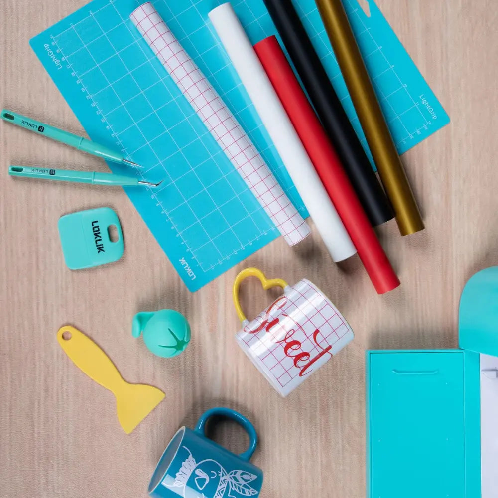 Craft starter pack accessories on table: blue cutting mat, ruler, markers, and shapes