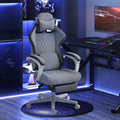 Grey high-back gaming chair with headrest, lumbar support, and reclining footrest