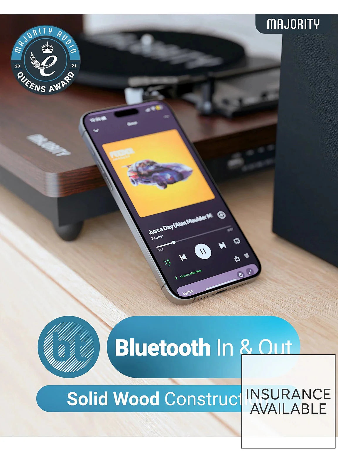 Turntable on desk with smartphone showing Bluetooth controls, dark wooden base