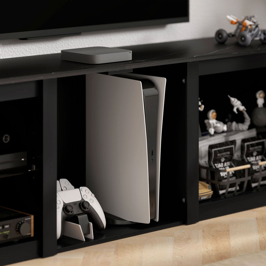 Black TV unit cabinet with open console compartment and media storage shelves on the side