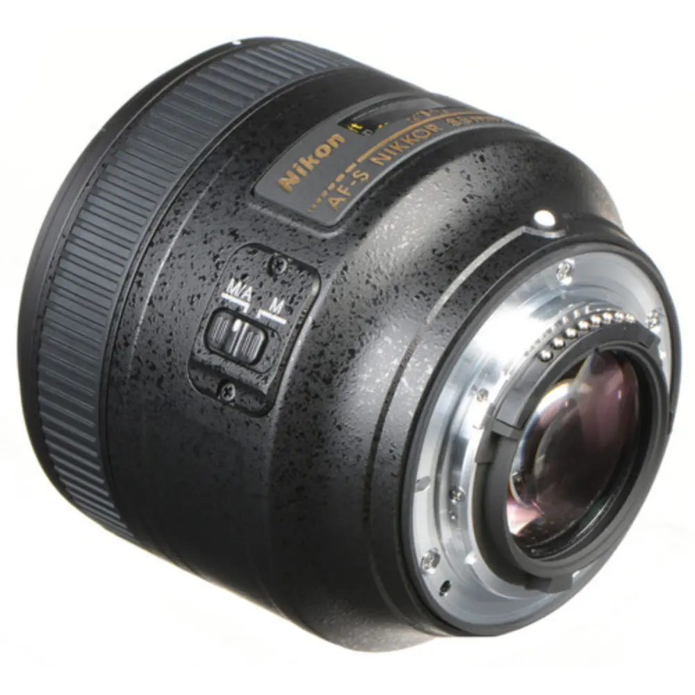 Black AF-S NIKKOR 85mm f/1.8G lens angled view with front glass and side switch