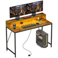 Rustic brown computer desk with LED strip, dual monitor stand, keyboard and mouse