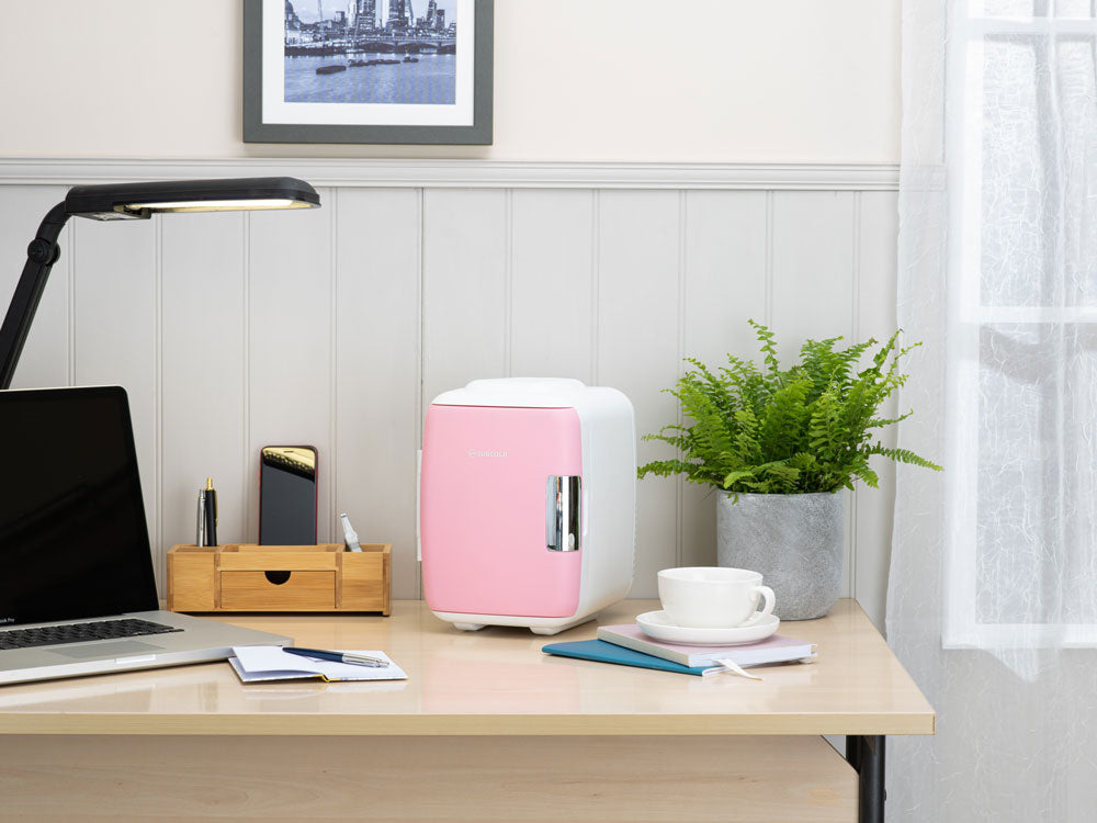 Subcold 4L mini fridge pink on desk with coffee cup and potted plant