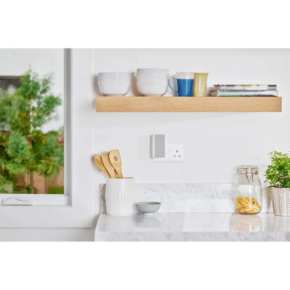 Ring smart chime mounted by wall outlet, small white device