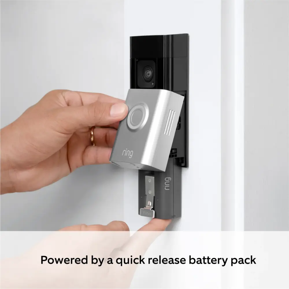 Hand removing quick-release battery pack from a silver RING video doorbell