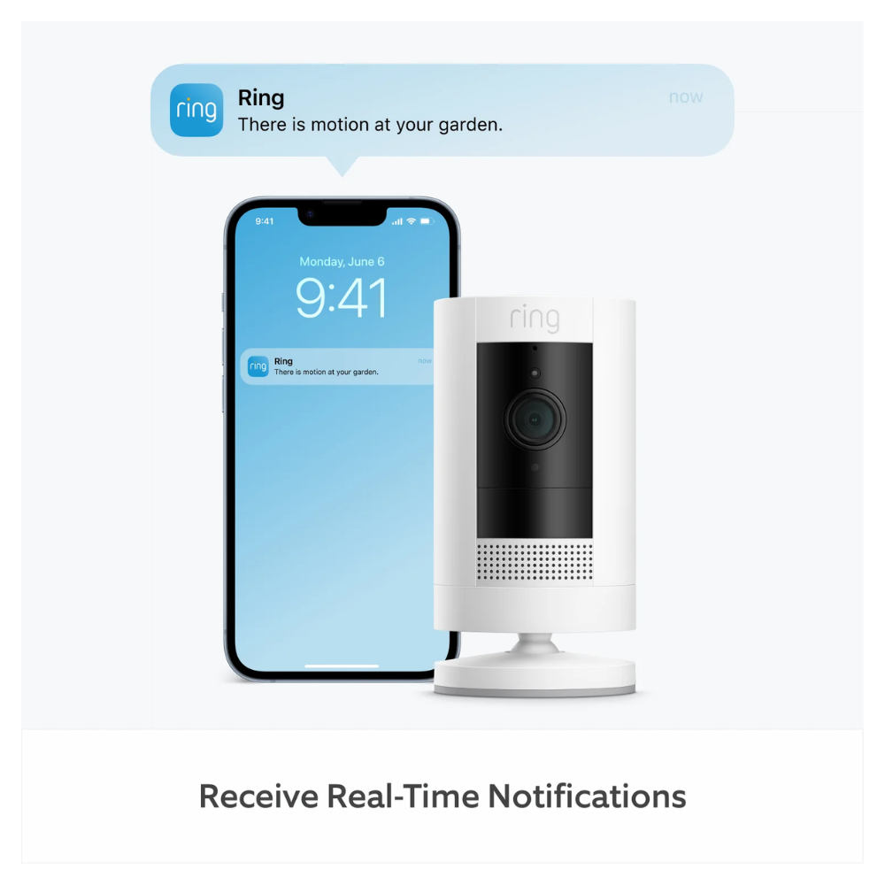 Outdoor security camera with smartphone showing app notification on screen