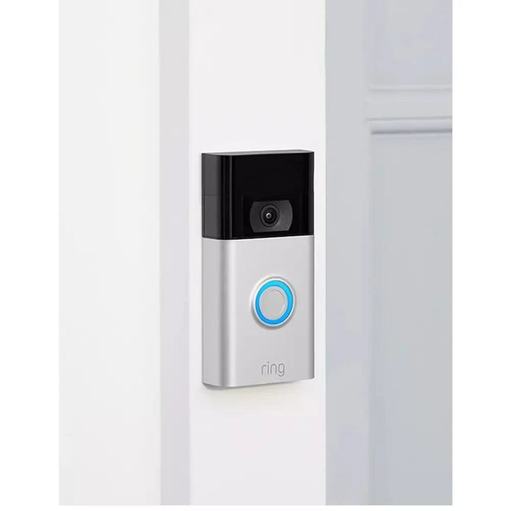 Silver video doorbell mounted on a wall with camera lens and blue door button