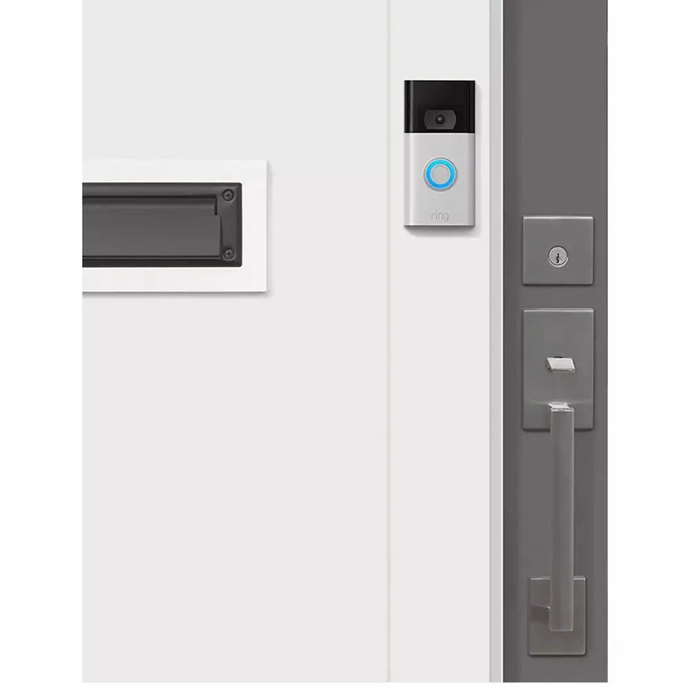 Wall-mounted video doorbell near a doorbell button and mailbox on a white door