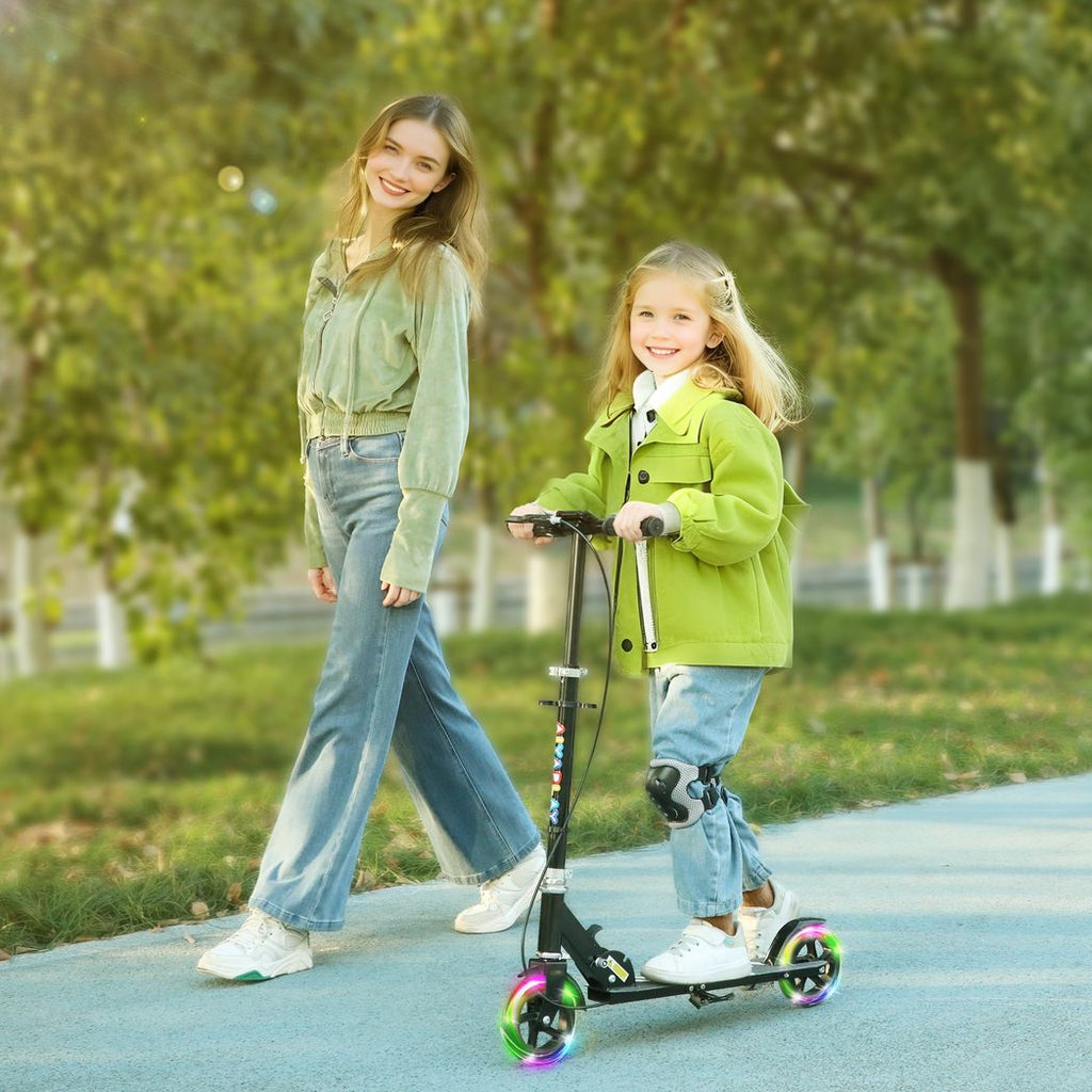 Kids folding kick scooter with black stem and multicolor wheels outdoors