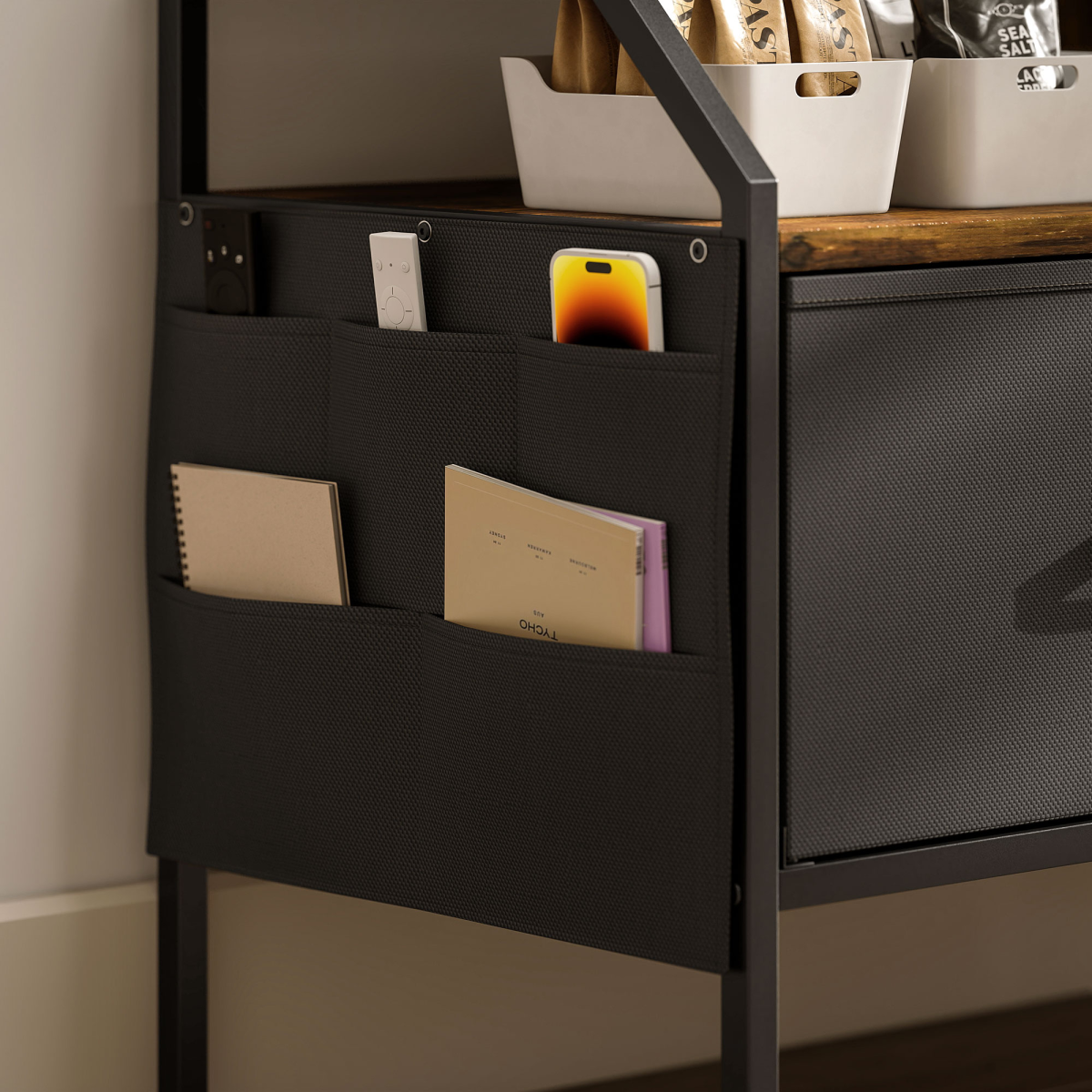 Close-up of foldable drawer interior with fabric storage pockets and paper items