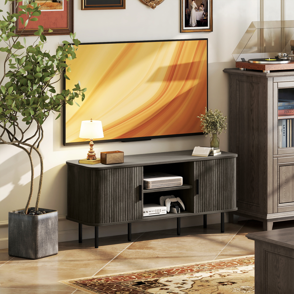Grey TV console with open cabinet shelves and middle drawer under the TV