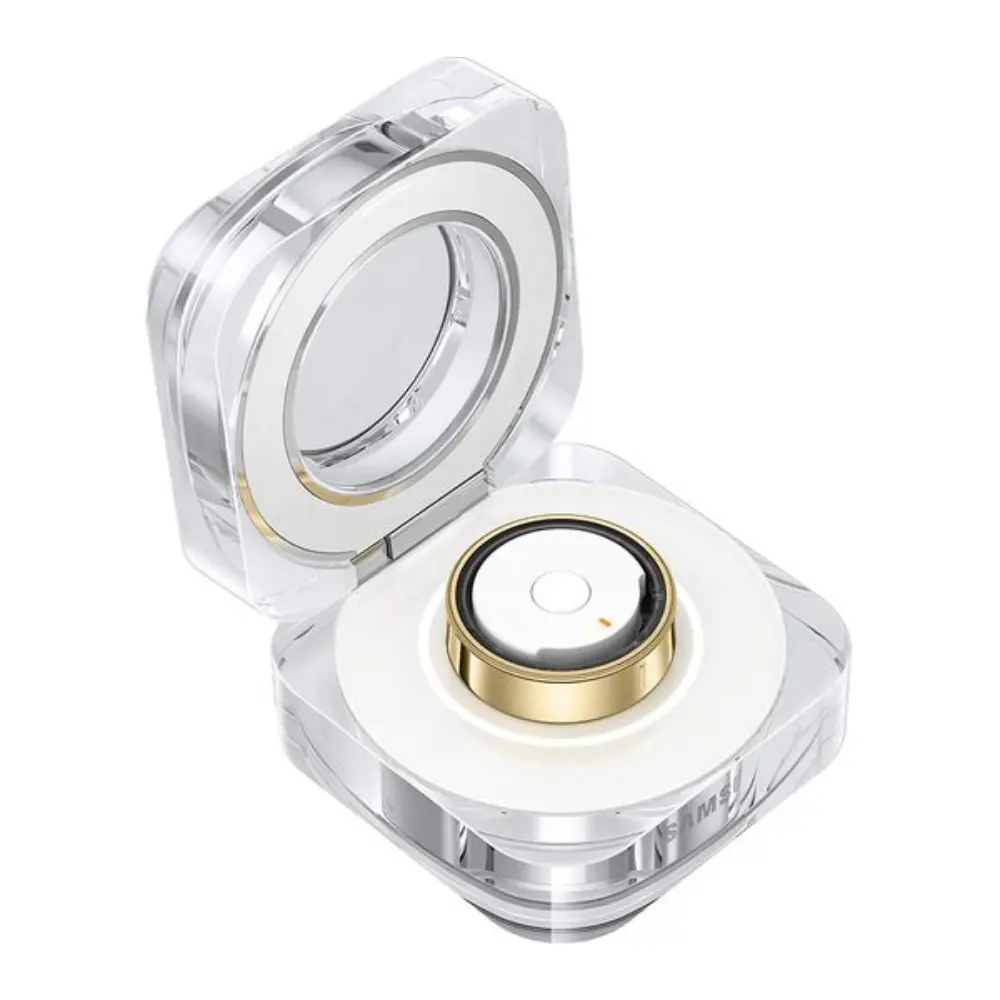 Titanium gold smart ring docked in clear charging case with open lid