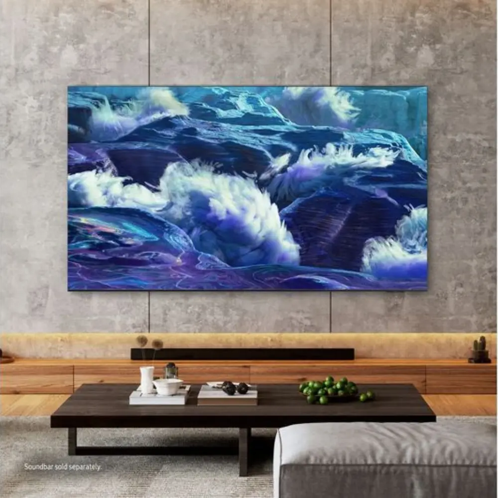 Smart TV with ocean-themed artwork on wall above media console