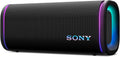 Black portable SONY speaker with fabric grille and blue LED light ring, cylindrical body.