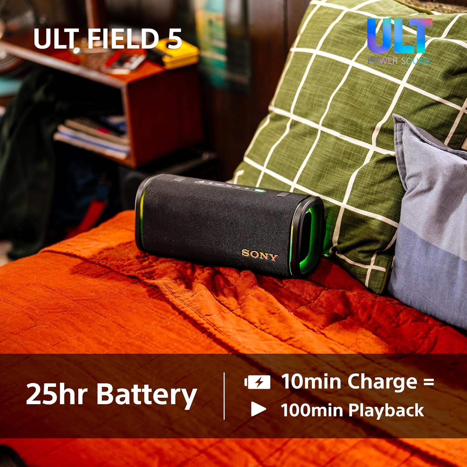 Black SONY portable speaker with green LED glow at the end, fabric grille finish.