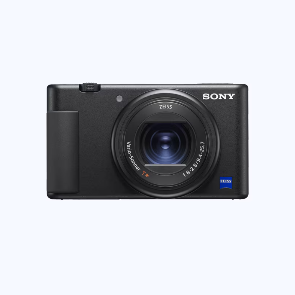 Front view compact camera with large lens, Zeiss branding, and built-in mic
