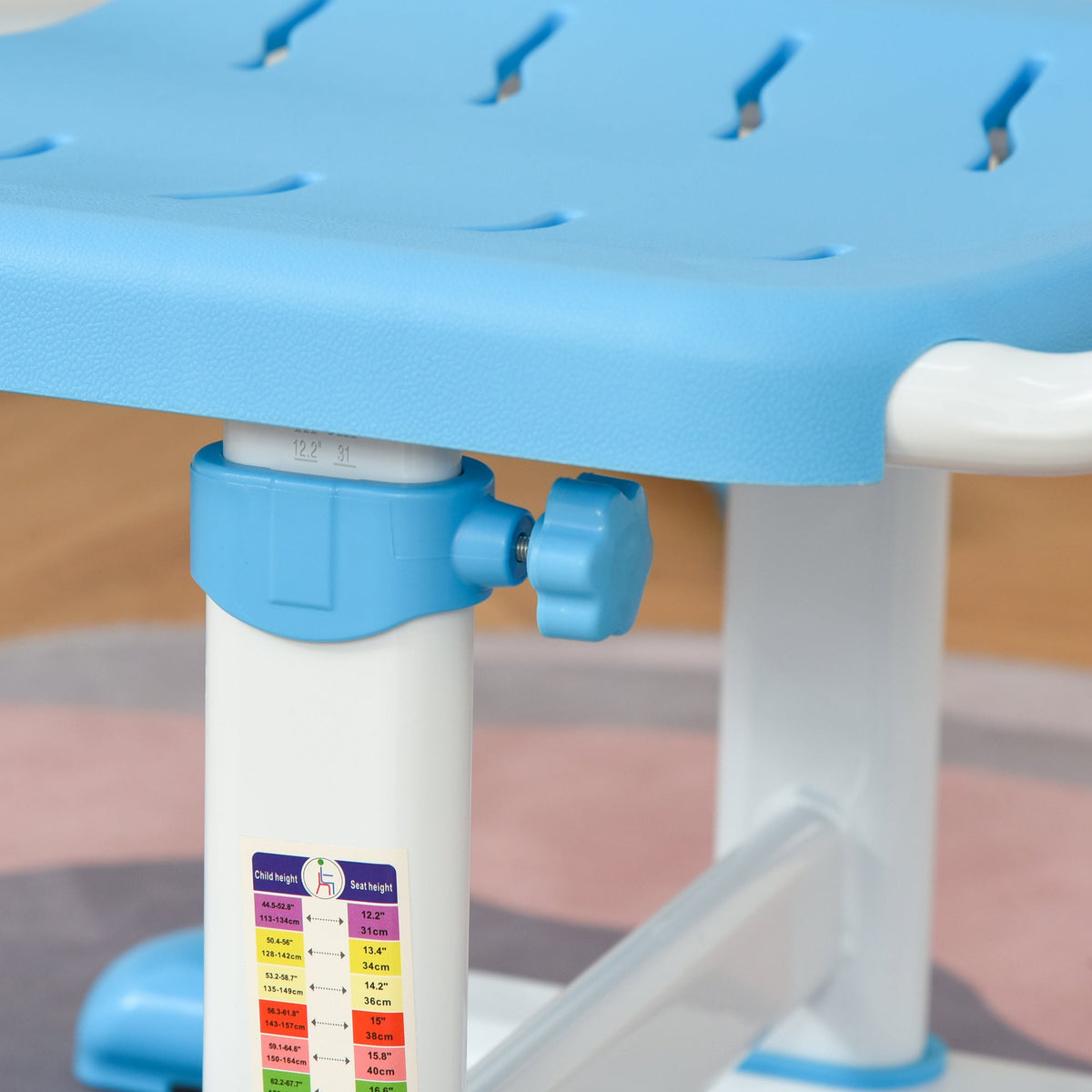 Desk height adjustment knob with measurement scale on white-and-blue frame