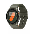Green smartwatch with round display, silver case, and dark green silicone band