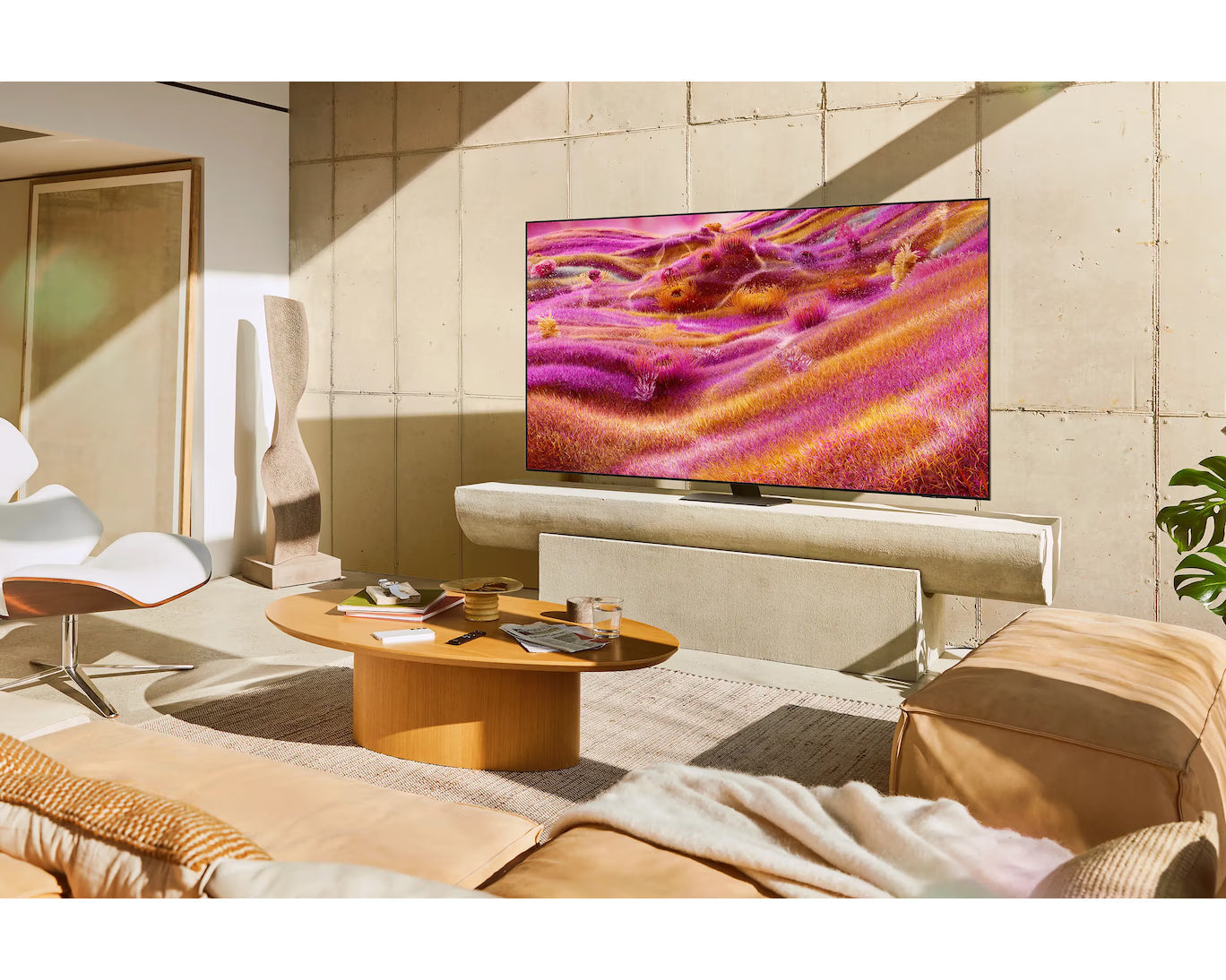Samsung Neo QLED 4K TV on wall above console, colorful beach display