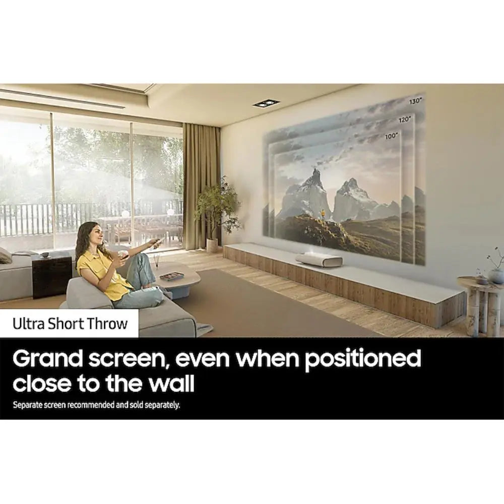 White Samsung Premiere projector positioned near the wall with a projected image on screen.