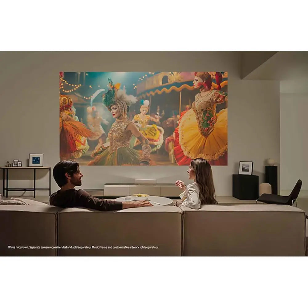 White Samsung Premiere projector on a stand, projecting a colorful scene for home theater.