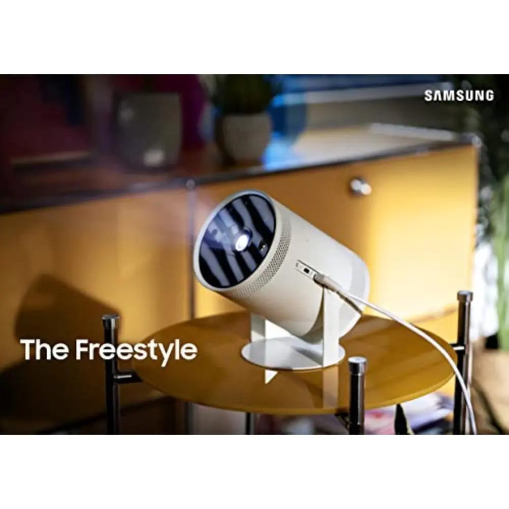White smart TV projector with black lens and connected cable on stand