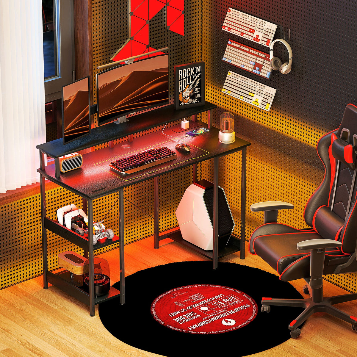 Black gaming computer desk with open shelves and blue LED glow under work surface