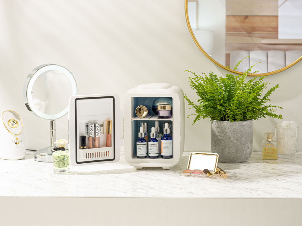 White mini fridge with door open on a countertop, bottles and small items inside