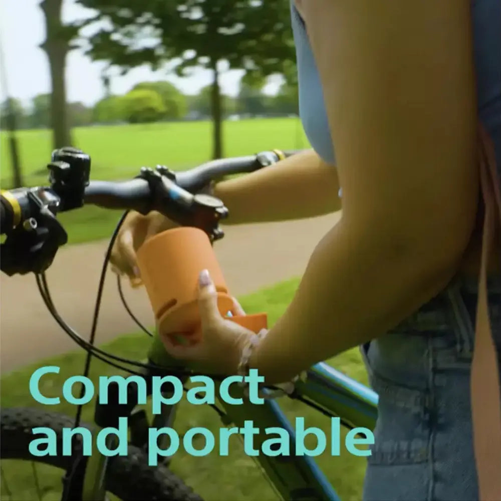 Sony SRS-XB100 portable Bluetooth speaker, blue cylinder near bicycle handlebars
