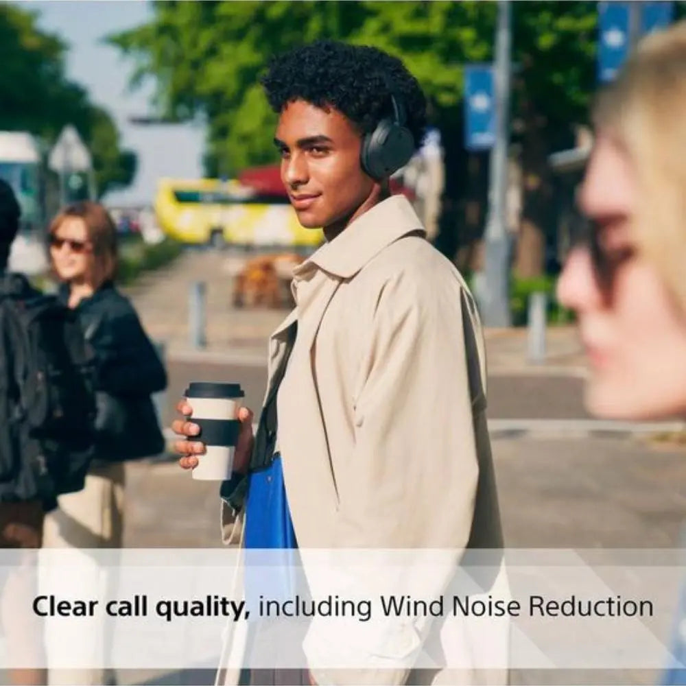 Wireless noise-cancelling over-ear Bluetooth headphones, dark finish, worn outdoors