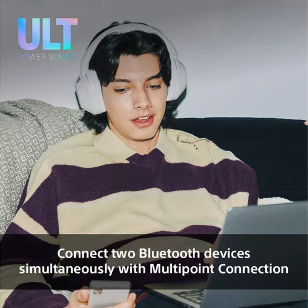 White over-ear wireless headphones worn by a person, padded headband and earcups