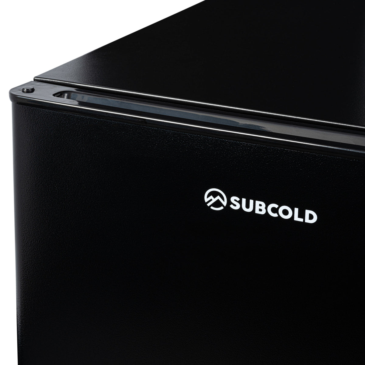 Black mini fridge close-up showing SUBCOLD logo on front panel
