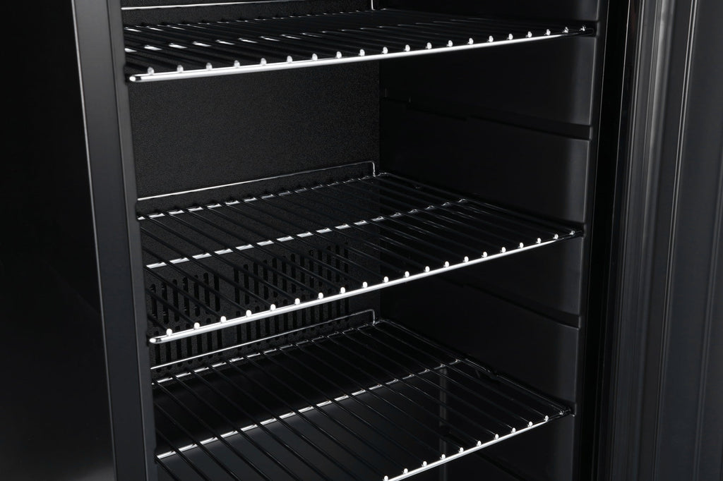 Open beer fridge interior with wire shelves and metal rails