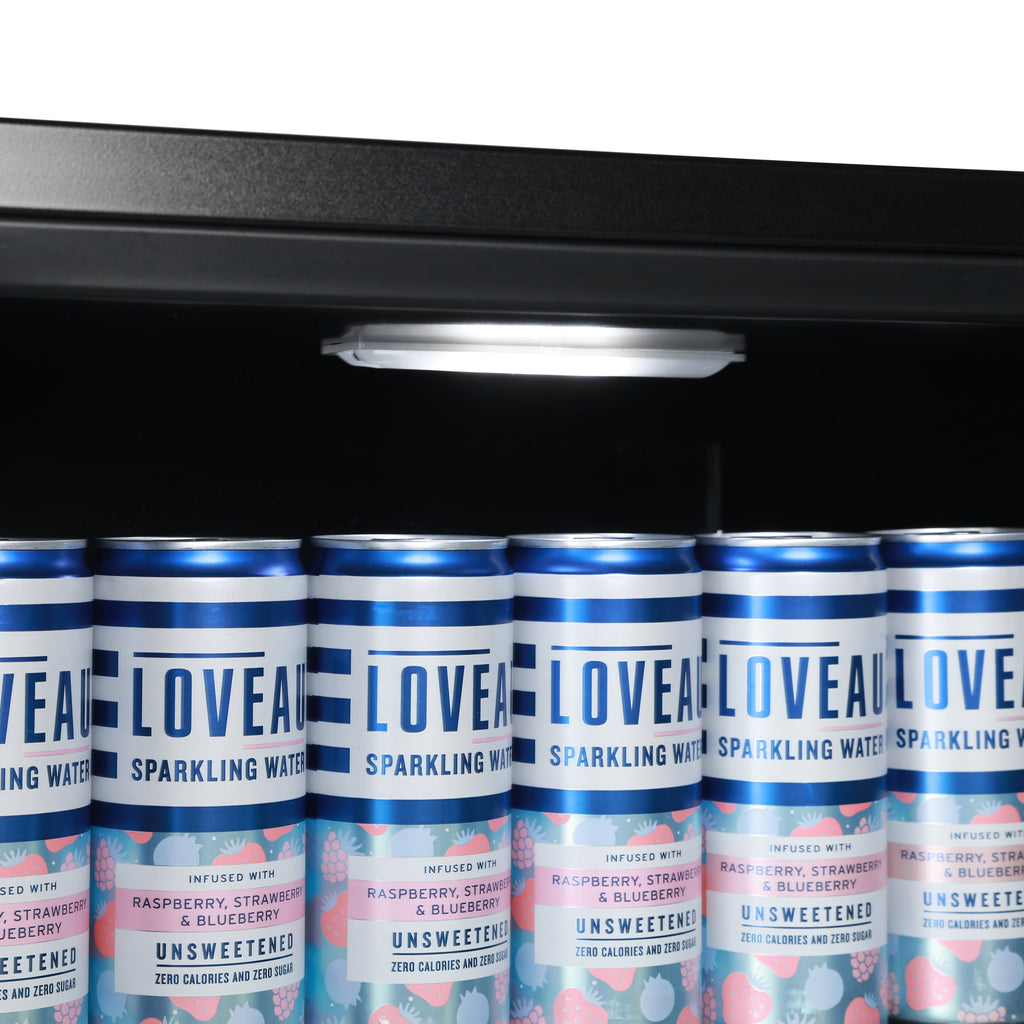 Beer fridge shelf with row of blue canned drinks under light
