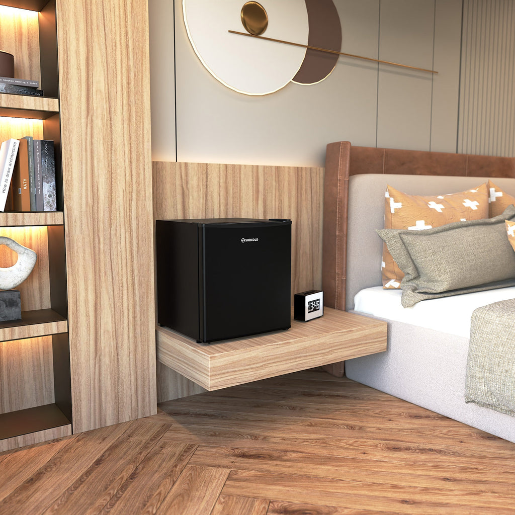 Black mini beer fridge with solid door in a home corner setup