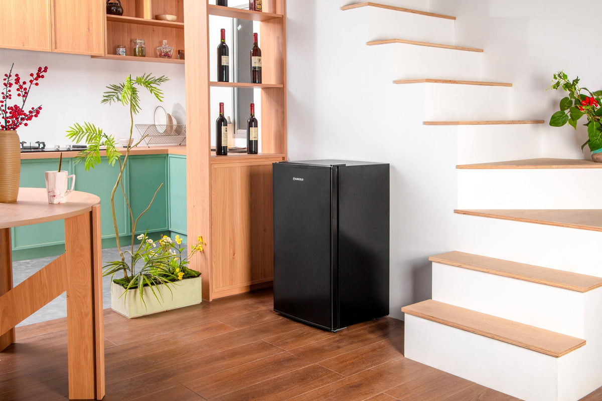 Black compact beer fridge with solid door and front control area