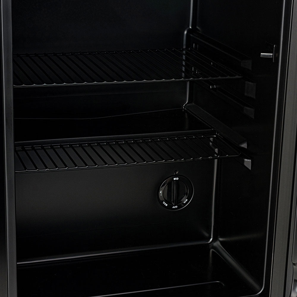Black beer fridge interior view with wire shelves and temperature control knob