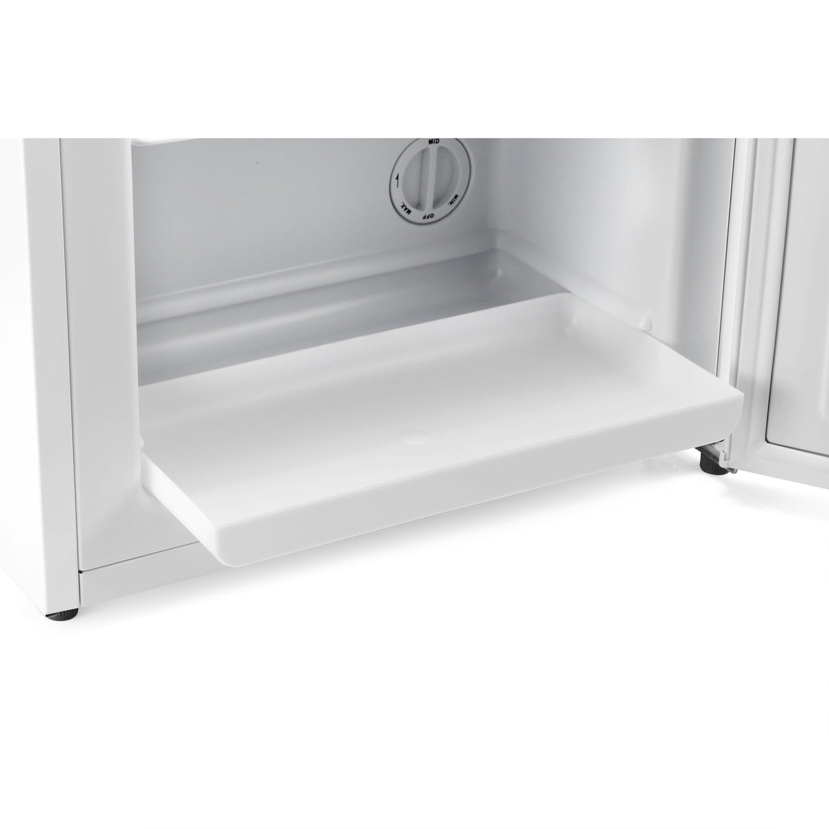 Mini freezer interior with lower pull-out tray and temperature dial behind