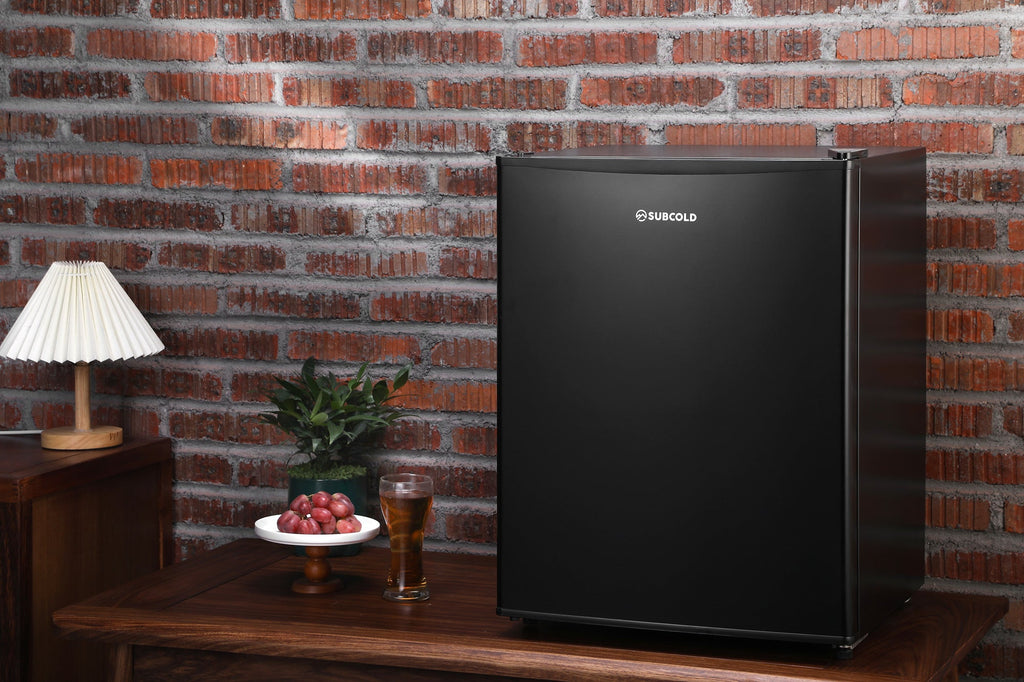 Black mini freezer standing with Subcold logo on the front door