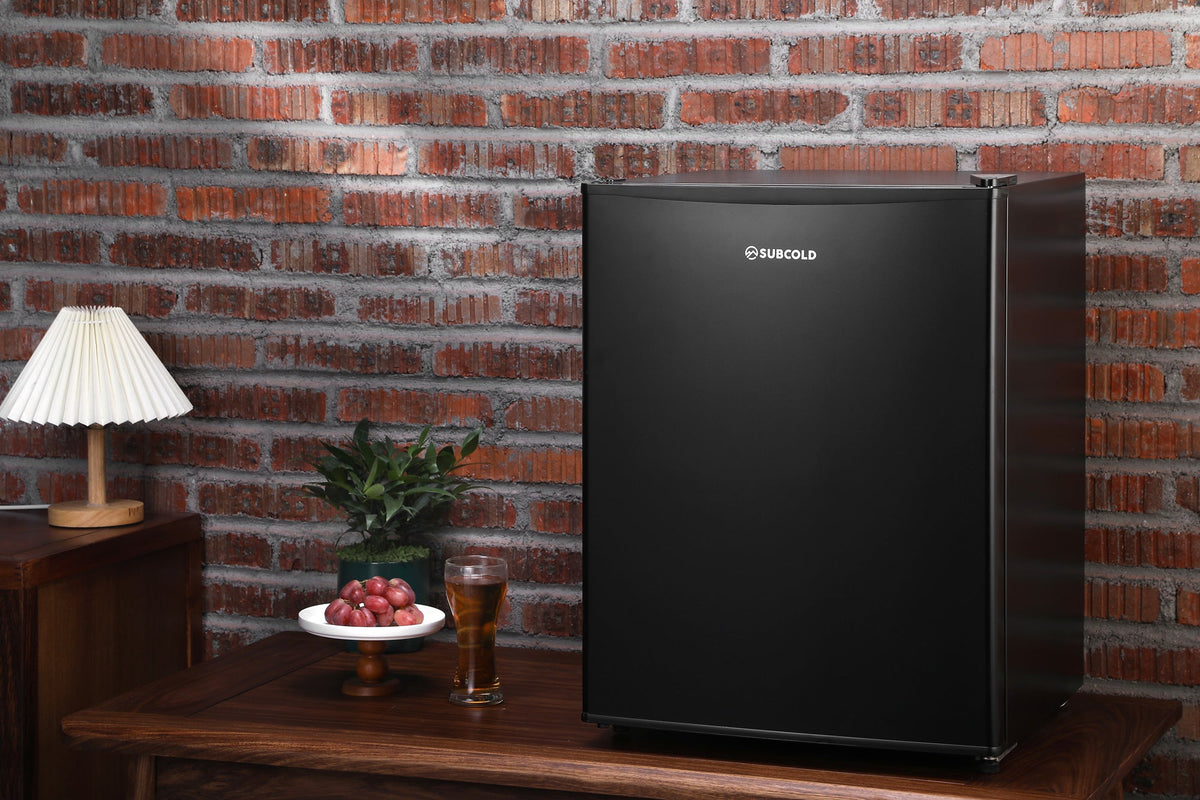 Black mini freezer standing with Subcold logo on the front door