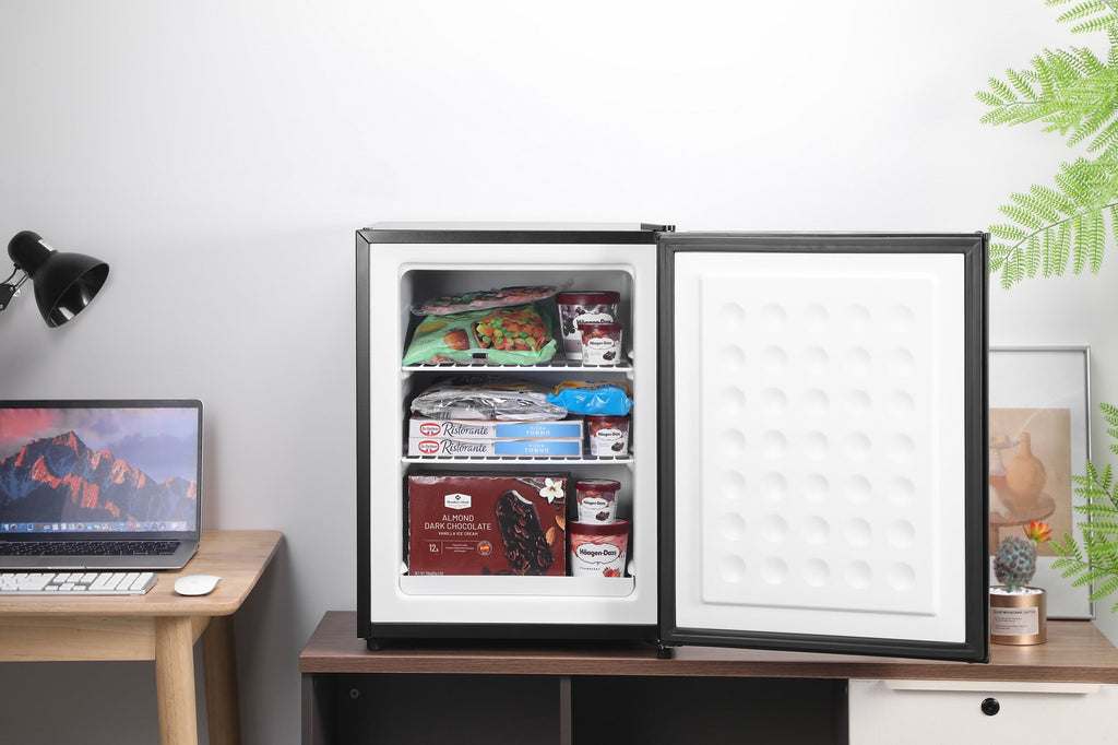 Black mini freezer with open door, interior shelves stocked with food