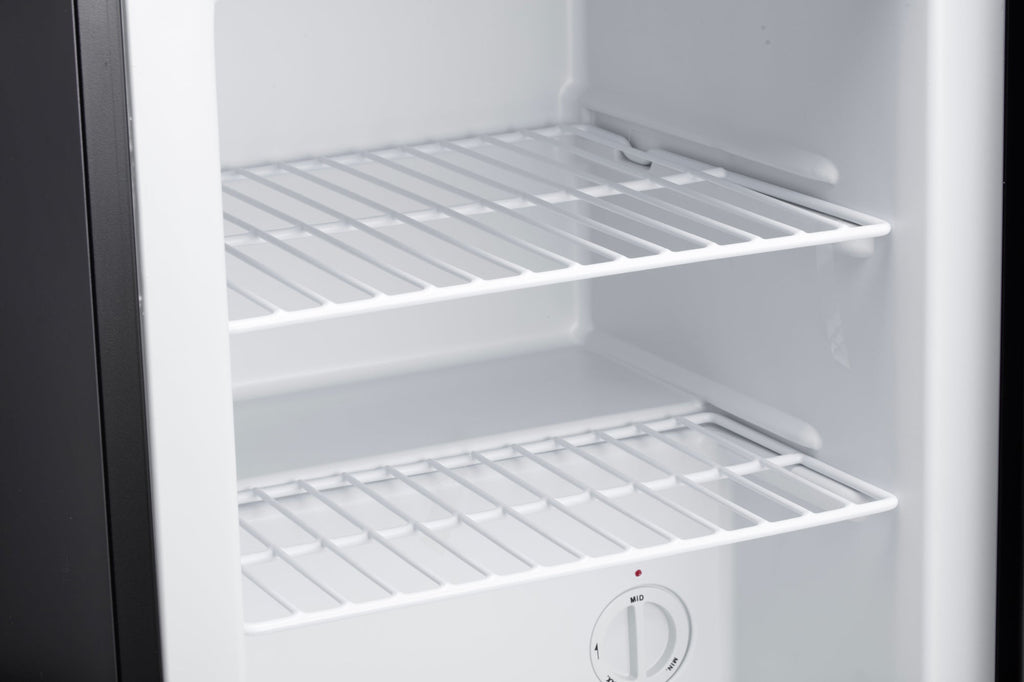 Mini freezer interior with white wire shelves and storage racks