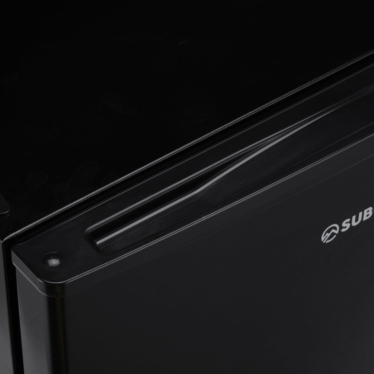 Black mini freezer top edge with recessed handle and side branding