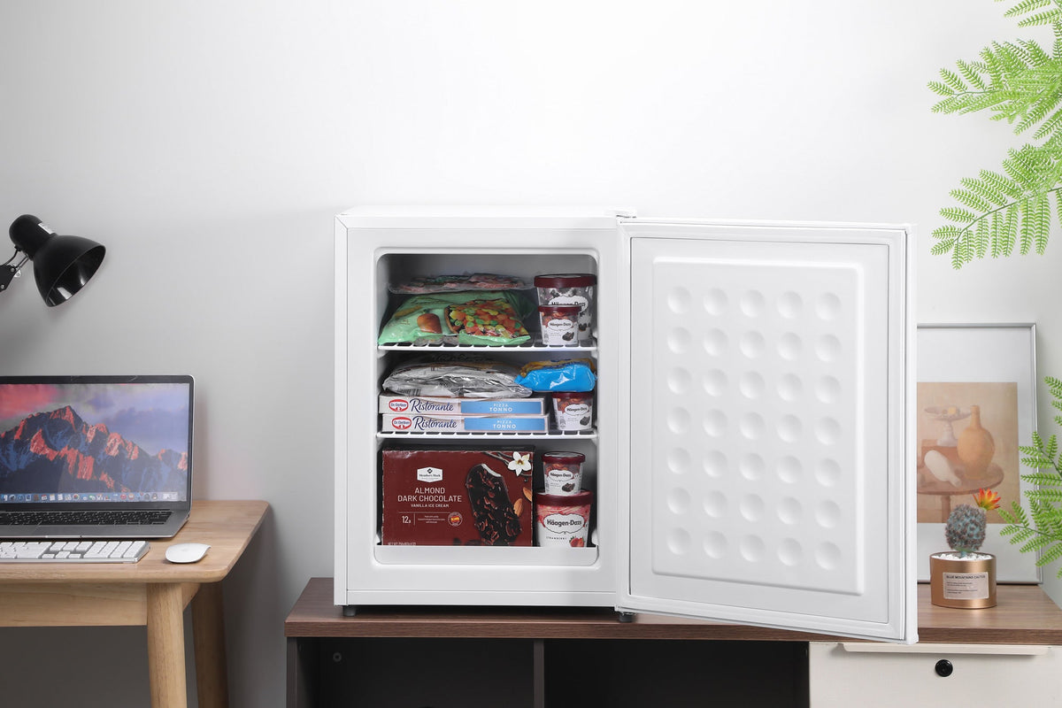 White mini freezer with door open, stocked with packaged food