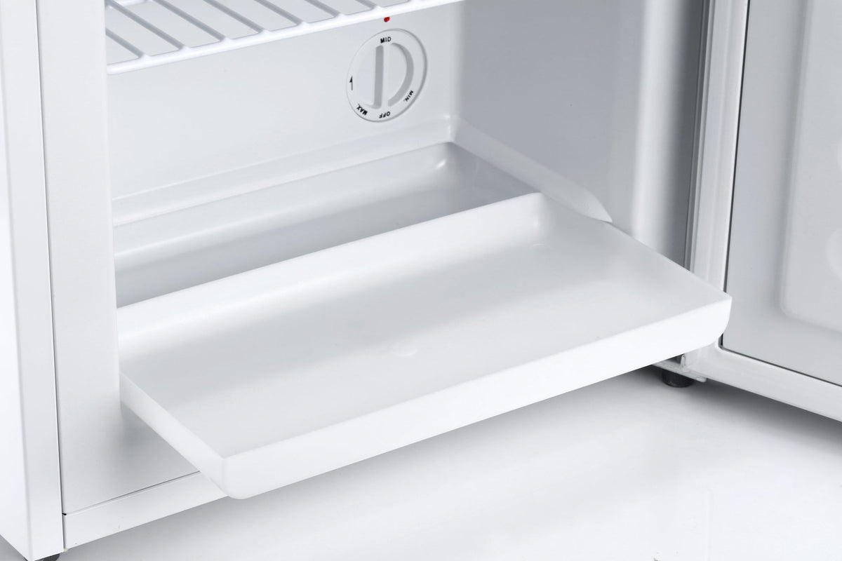 Open white mini freezer interior with shelf and temperature control dial