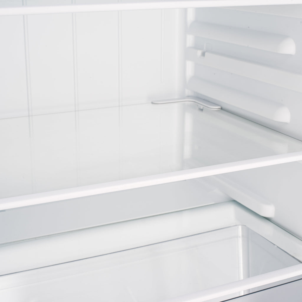 Under-counter fridge interior shelf with white slats and metal supports