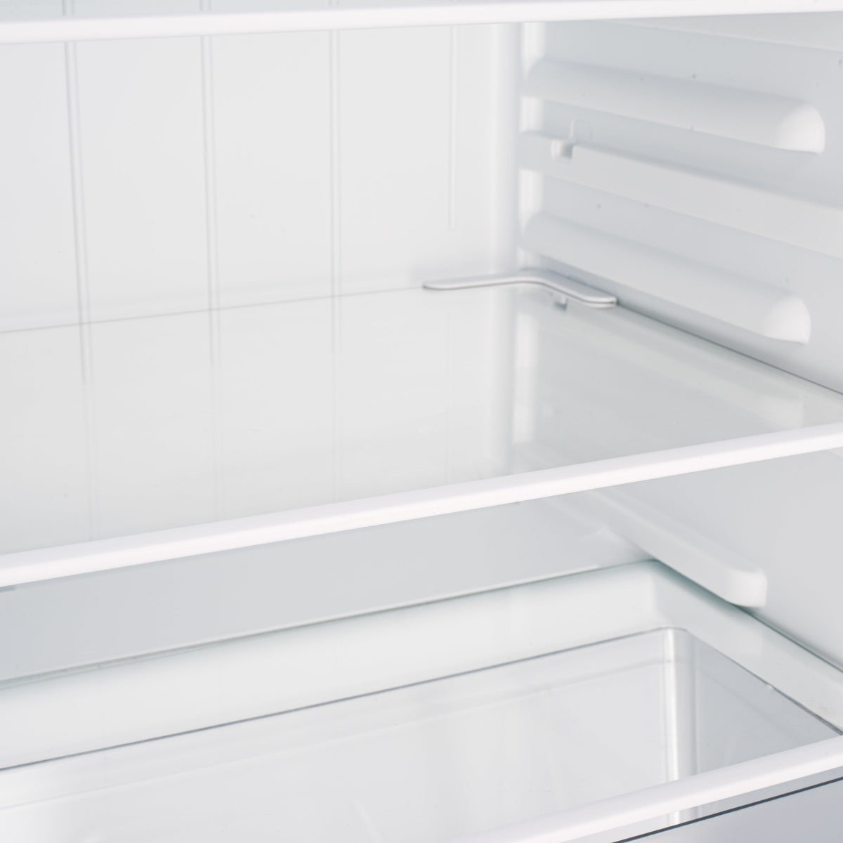 Under-counter fridge interior shelf with white slats and metal supports