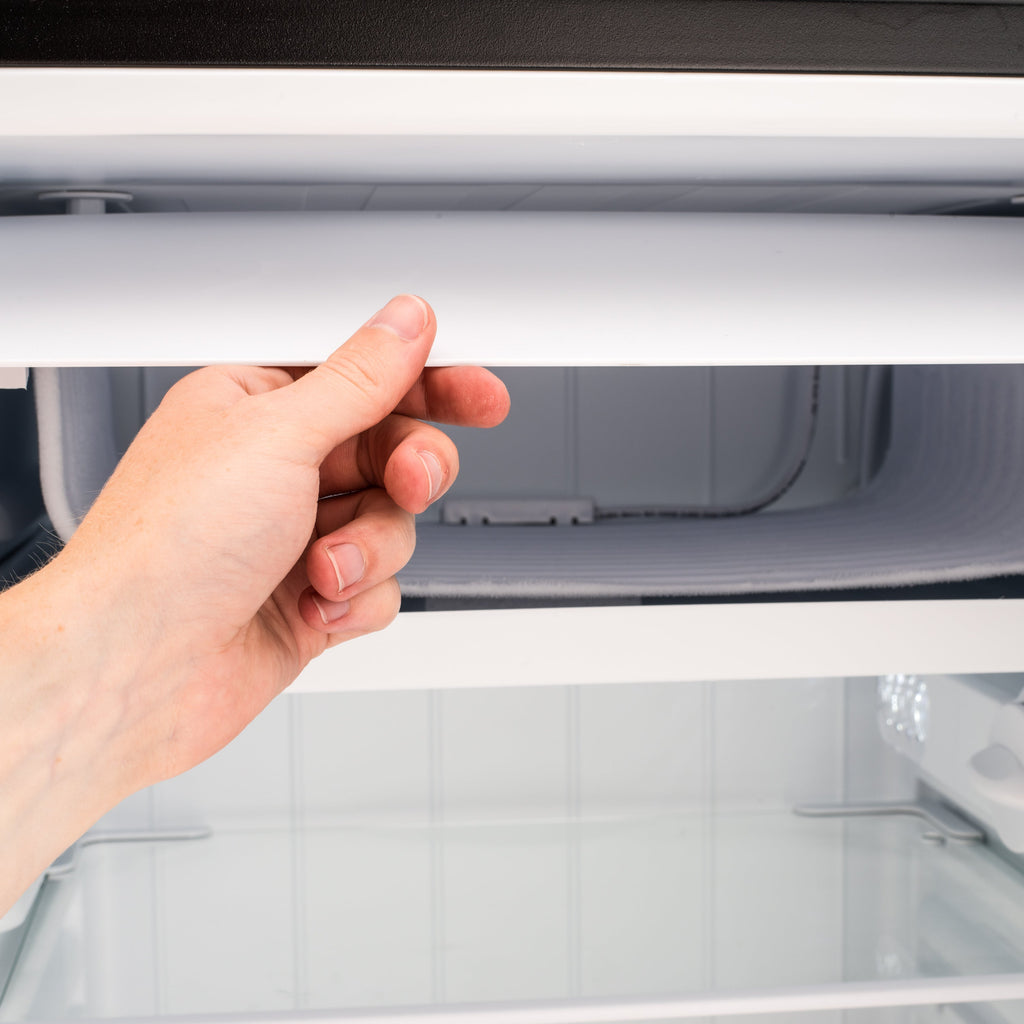 Under-counter LED fridge, open door showing interior shelves and bottom compartment
